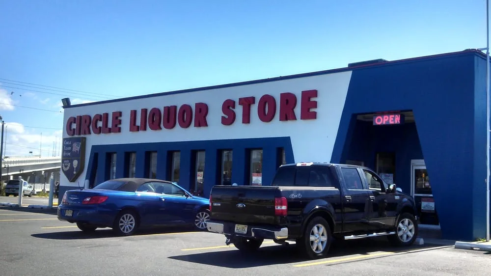 The blue and white Circle Liquor Store building in daylight at 1 MacArthur Boulevard