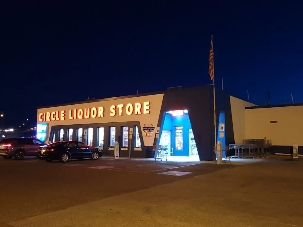 Circle Liquor Store's illuminated sign and storefront at night in Somers Point